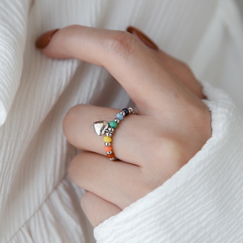 Nhẫn nữ titan kiểu xâu chuỗi bi tròn và thủy tinh màu sắc charm mặt cười trái tim xinh xắn không gỉ WE2209