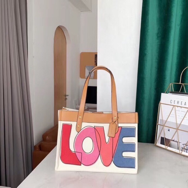 Coach tote 33 with best sale love print