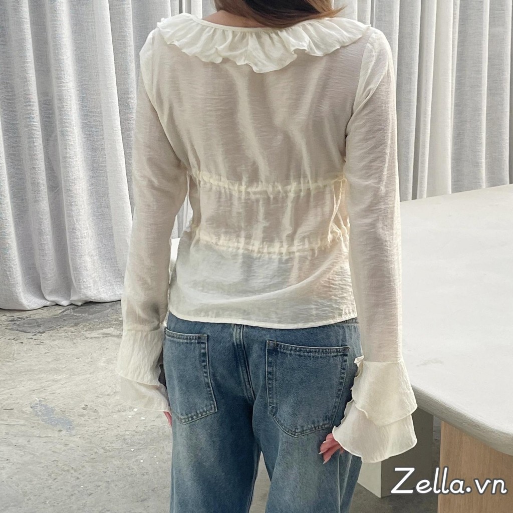 Áo sơ mi nữ thiết kế dáng rộng phía trước có nơ, tay dài, cổ chữ V và phần eo xòe ra (peplum)