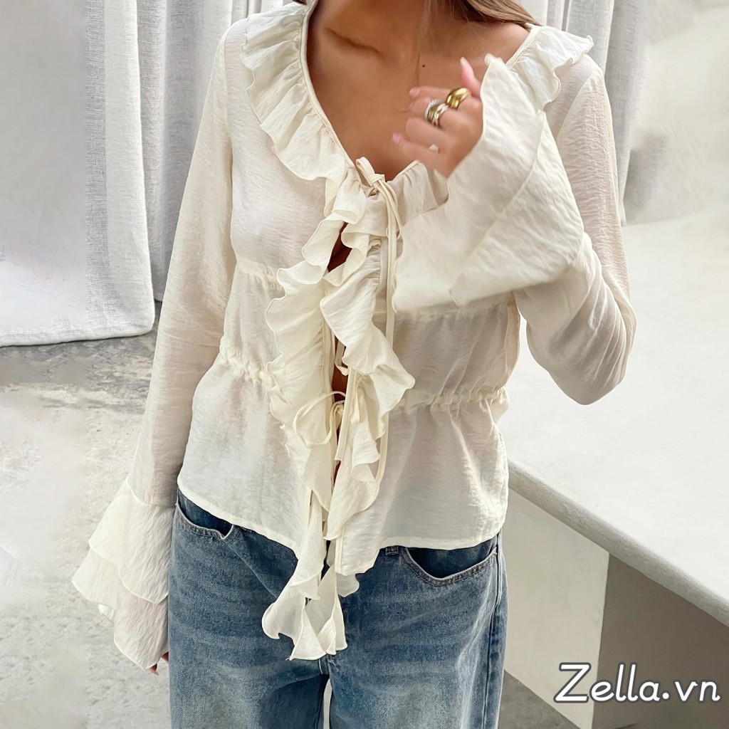 Áo sơ mi nữ thiết kế dáng rộng phía trước có nơ, tay dài, cổ chữ V và phần eo xòe ra (peplum)