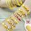 2026 Xuân Hè Sanrio Pudding Chó Món Tráng Miệng Màu Vàng Chuyển Hạt Cát Vàng Nhỏ Đính Hạt Mặt Dây Chuyền Phụ Kiện Nữ
