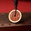Dây chuyền handmade cổ điển với họa tiết núi ma và đồng xu cinnabar