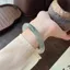 Vòng tay đá tuyết ngọc vàng lụa từ Tân Cương với họa tiết nổi hoa đẹp mắt