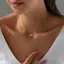 Vòng cổ chữ thập và vòng tay từ thép titan mạ vàng 18K
