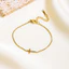 Vòng cổ chữ thập và vòng tay từ thép titan mạ vàng 18K