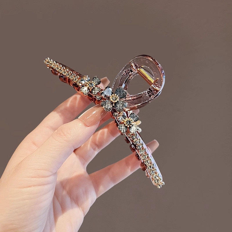 Kẹp tóc MAUROPOLI với kim cương giả và cỏ bốn lá, thiết kế sang trọng và cổ điển, phù hợp cho những người yêu thích sự tinh tế.