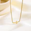 Vòng cổ chữ thập và vòng tay từ thép titan mạ vàng 18K