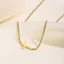 Vòng cổ chữ thập và vòng tay từ thép titan mạ vàng 18K