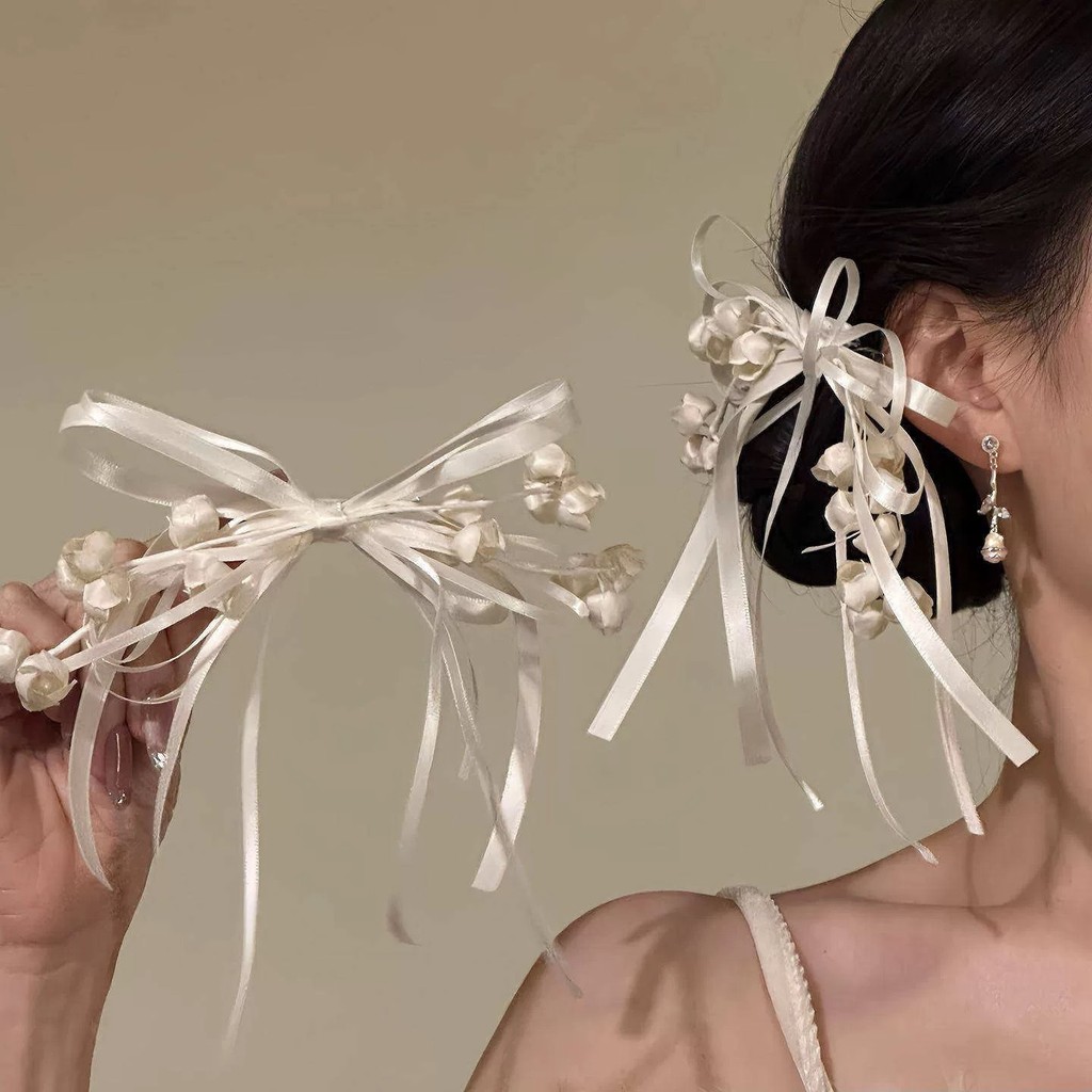 Kẹp tóc hoa huệ màu hồng thanh lịch của thung lũng và nơ dành cho nữ