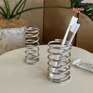 Giá đựng cọ trang điểm để bàn bằng sắt, có lỗ thoát nước, dạng khoét rỗng.