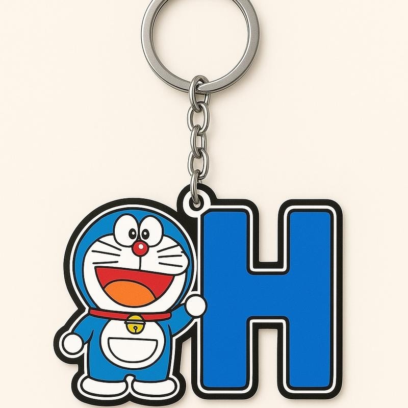Doraemon móc khóa dành tă với hình Doraemon và chữ cái màu xanh nổi bật