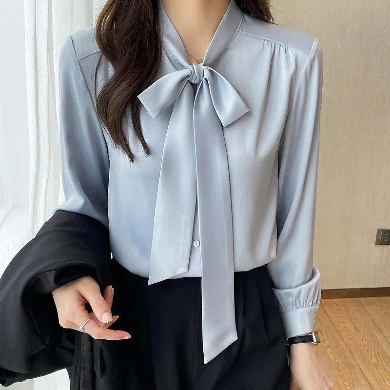 Áo sơ mi thu đông nữ phong cách Hàn Quốc, chất liệu satin với nơ đen.