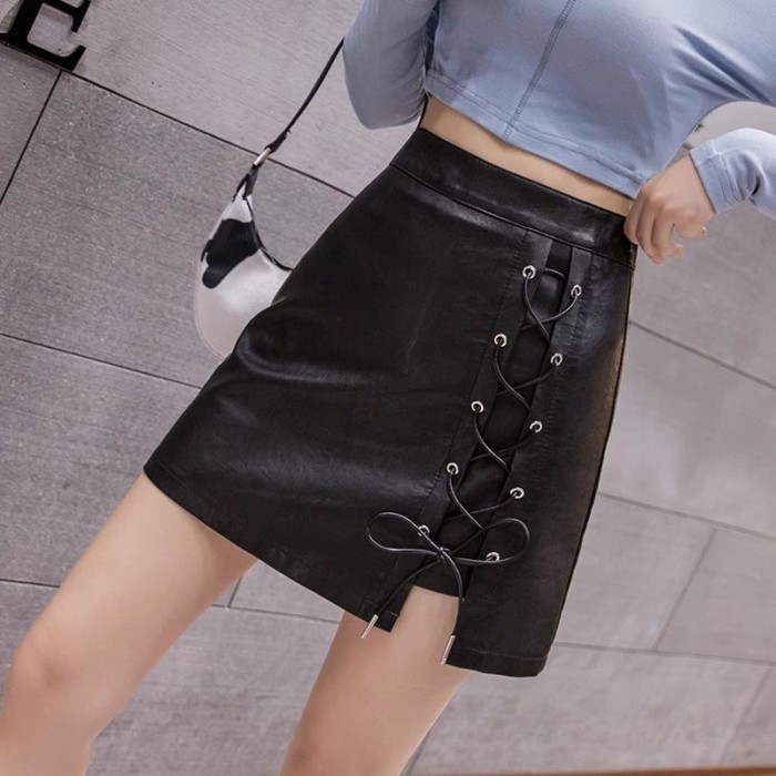 Váy dây chéo không đều Váy da PU chống lộ màu đen lưng cao Váy chữ A Váy che hông dành cho nữ