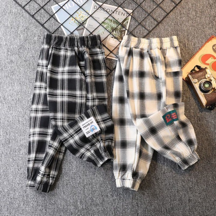 Quần kẻ sọc xuân thu bé trai mới quần legging rộng rãi cho trẻ em từ trung niên trở lên quần