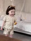 Bộ quần áo mặc nhà màu kem phủ hoa cho bé gái mùa hè mỏng áo ngắn tay và quần dài Bộ hai món pho