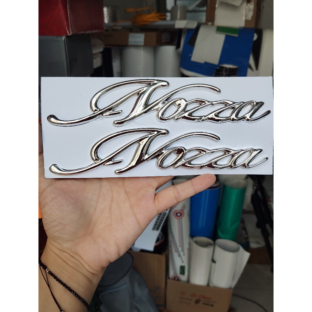 Tem Nozza chữ nổi ốp sườn. Logo dán xe Honda Nozza xi mạ cao cấp, có sẵn keo dán