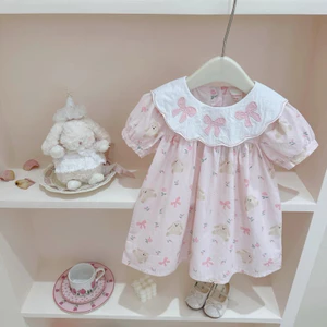 Váy cổ bèo thêu nơ dáng babydoll hoạ tiết gấu nơ dành cho bé gái