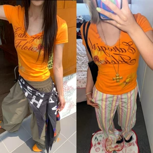 Áo baby tee màu cam cháy cổ V và cổ tròn hoạ tiết bông hoa ABBT057 - TikTik