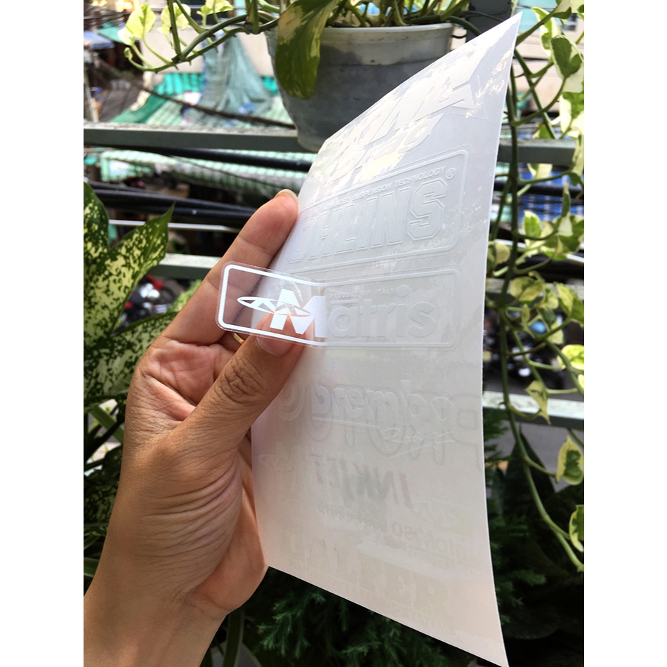 Tờ KINGDRA-OLINS chữ trắng in UV nền trong suốt. Decal chống nước. Logo Sticker cao cấp