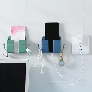 Kệ Đựng Remote - Điện Thoại Có Lỗ Cắm Sạc Dán Tường Có 2 Móc Treo Đồ
