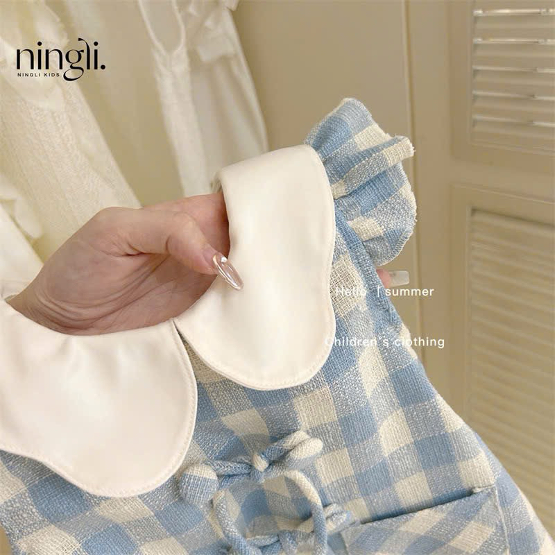 (Sẵn 90) Váy cổ bèo kẻ caro tay xoè đính khuy nơ phong cách Hàn Quốc dành cho bé gái