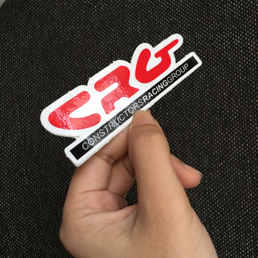 Logo CRG[10.7x3.3cm] nền trắng chữ đỏ. Hình dán decal siêu dính, chống nước, tem đua trang trí