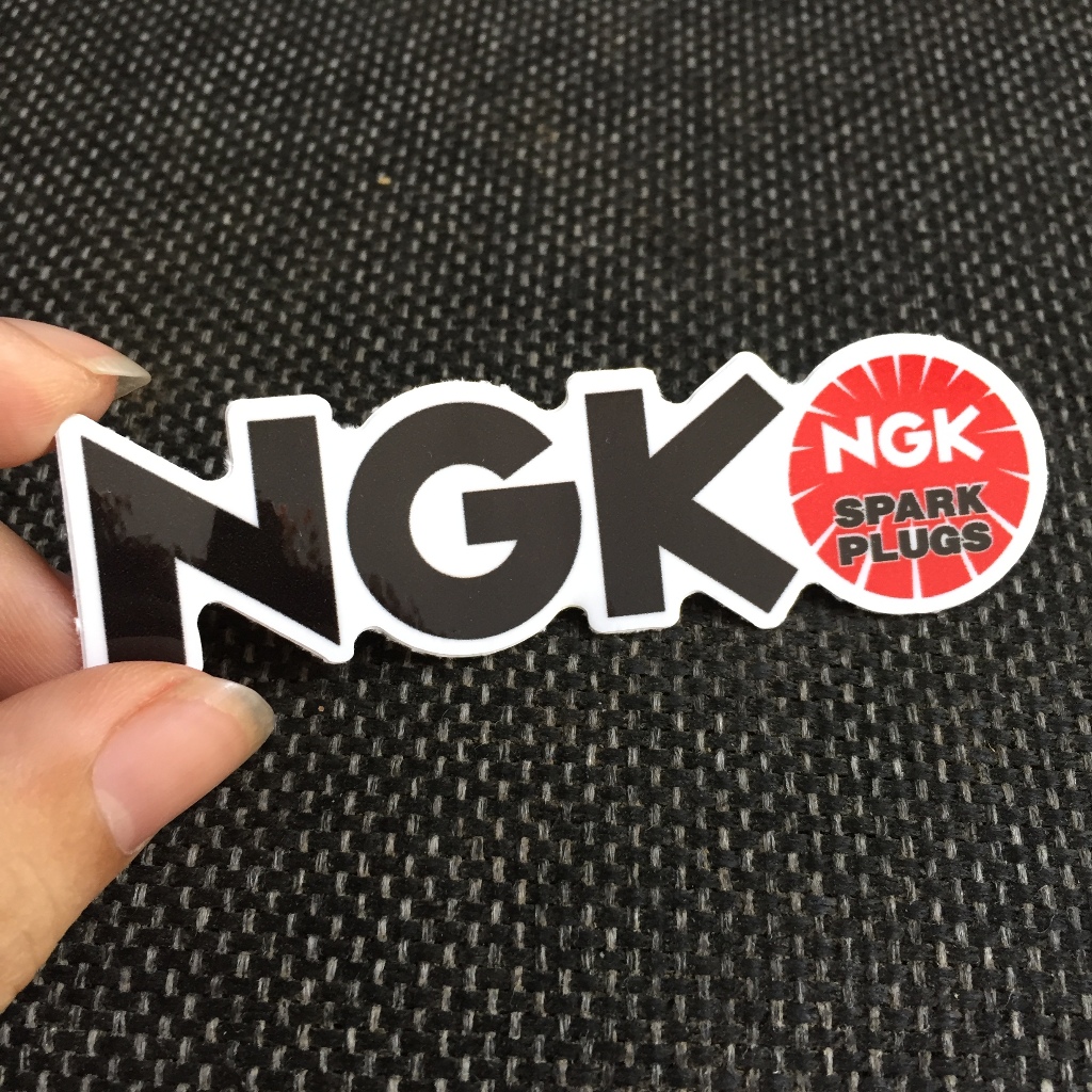 NGK[8.5X2.4cm] decal cao cấp chống nước, sắc nét, bền màu, dính chặt. Hình dán logo trang trí mọi nơi, in theo yêu cầu
