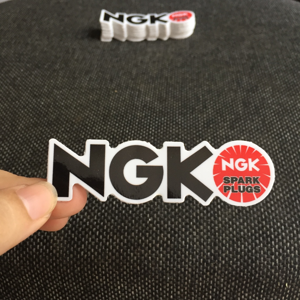 NGK[8.5X2.4cm] decal cao cấp chống nước, sắc nét, bền màu, dính chặt. Hình dán logo trang trí mọi nơi, in theo yêu cầu