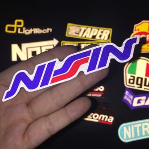Logo NISSIN[11.2x2cm] decal phản quang 3M cao cấp chống nước. Hình dán sắc nét, bền màu, dính chặt.
