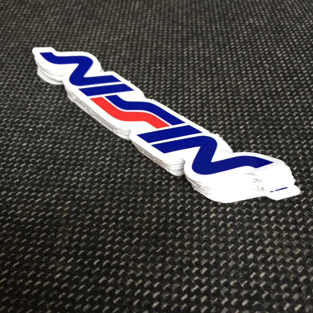 NISSIN[11.2x2cm] decal cao cấp chống nước, sắc nét, bền màu, dính chặt. Hình dán logo trang trí mọi nơi, in theo yêu cầu