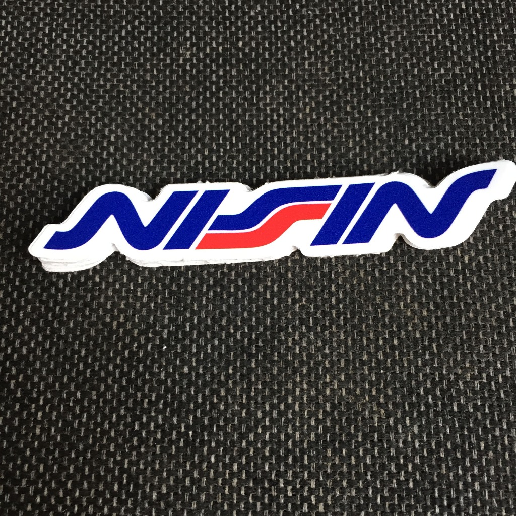 NISSIN[11.2x2cm] decal cao cấp chống nước, sắc nét, bền màu, dính chặt. Hình dán logo trang trí mọi nơi, in theo yêu cầu
