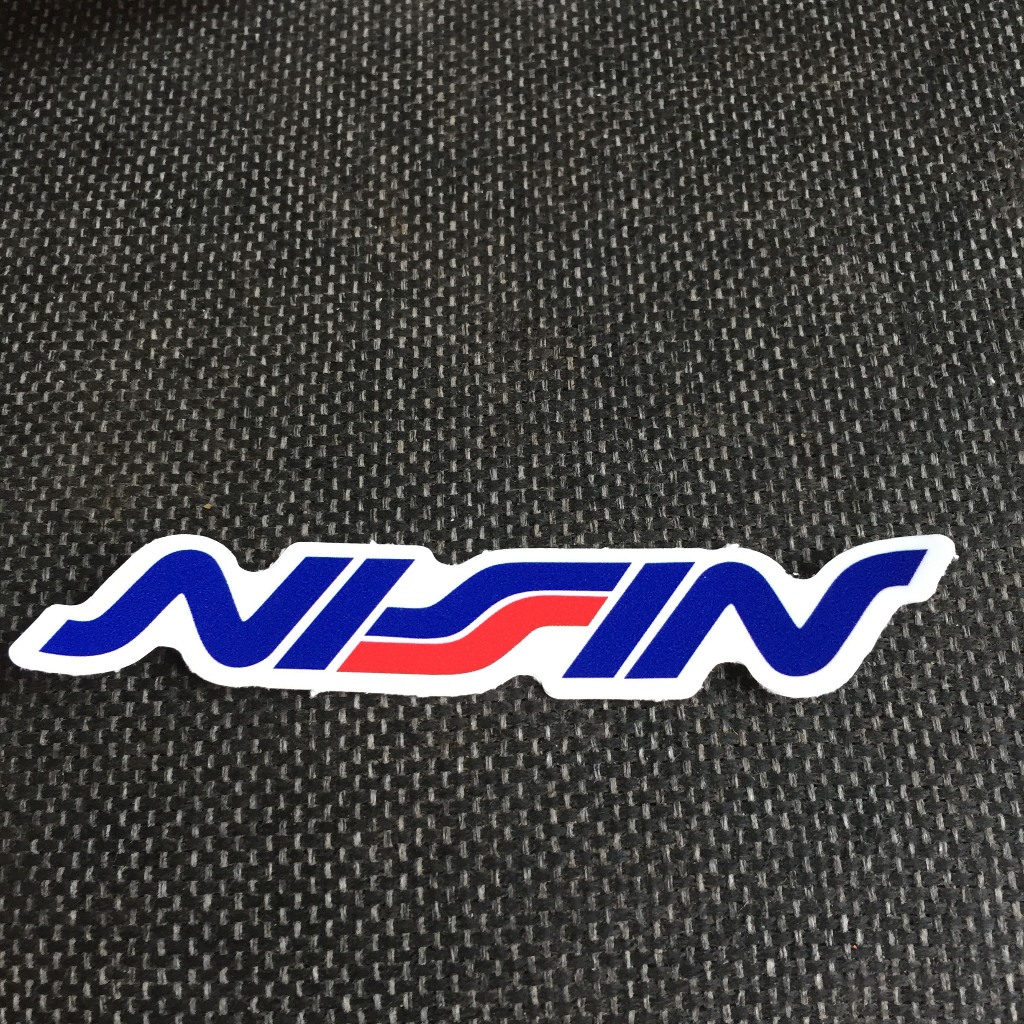 NISSIN[11.2x2cm] decal cao cấp chống nước, sắc nét, bền màu, dính chặt. Hình dán logo trang trí mọi nơi, in theo yêu cầu