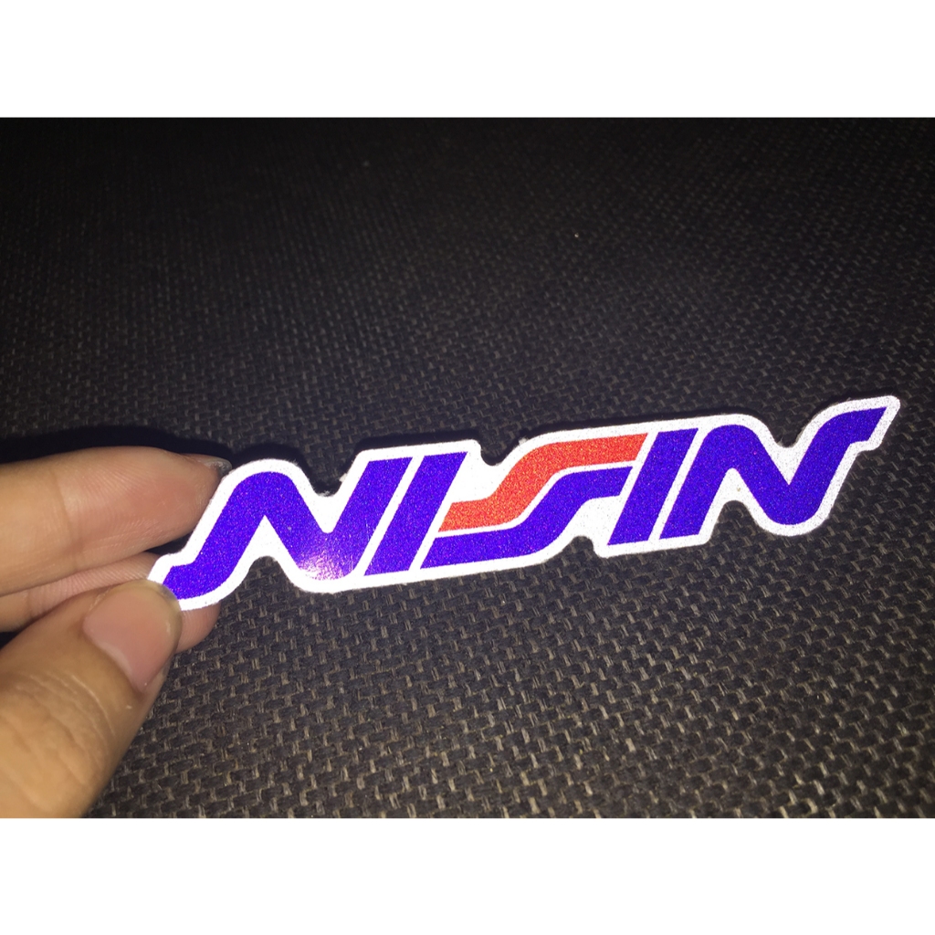 Logo NISSIN[11.2x2cm] decal phản quang 3M cao cấp chống nước. Hình dán sắc nét, bền màu, dính chặt.