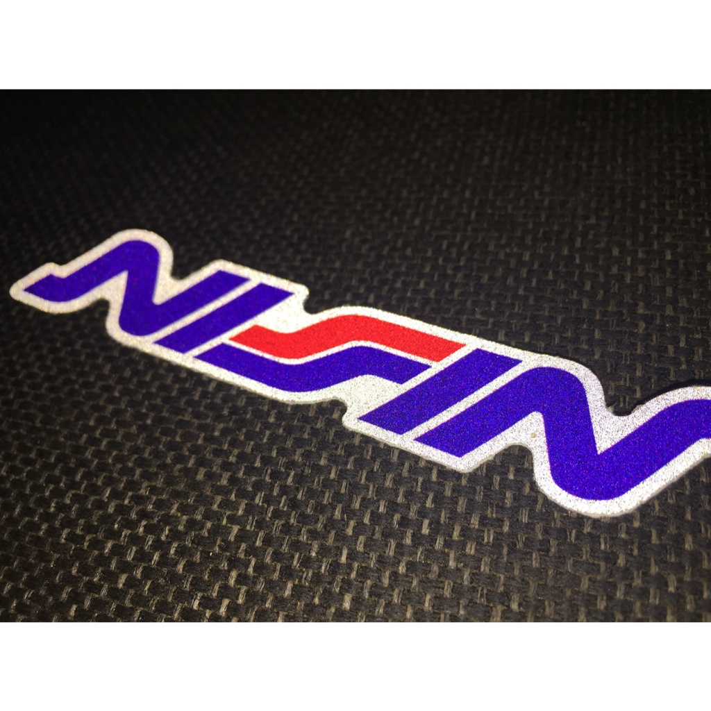 Logo NISSIN[11.2x2cm] decal phản quang 3M cao cấp chống nước. Hình dán sắc nét, bền màu, dính chặt.
