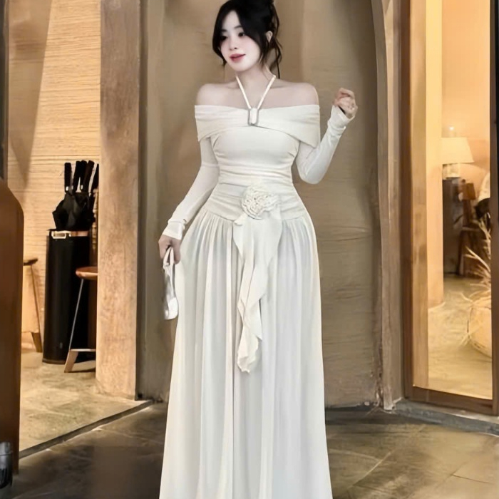 Đầm trễ vai tay dài có dây yếm kết khoen,nhúng hông đính hoa tua rua dáng dài rộng