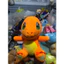 Gấu 2hand gấu bông Pokémon Charmander với đặc điểm nổi bật là màu cam rực rỡ và chiếc đuôi có ngọn lửa màu đỏ vàng.