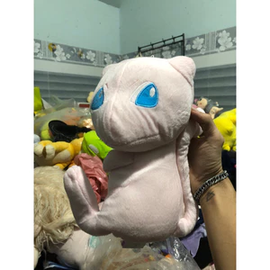 Gấu 2hand Thú bông Pokémon Mew này có thiết kế màu hồng nhạt đặc trưng cùng đôi mắt màu xanh dương thêu tinh xảo.