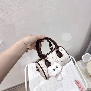 Túi xách nữ mini ,cầm tay họa tiết mèo đáng yêu size 17cm dáng trống kèm charm bông cute - TXN086