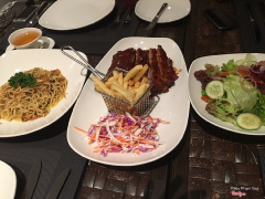 From left: seafood pasta, cajun pork and green salad