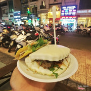 bánh bao kẹp thịt heo và bánh taco giòn màu vàng kế bên