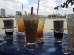 Cà phê sữa đá (iced coffees with milk), sinh tố (fruit shake), and a cool river breeze at Cafe A & B