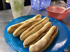 Banh mi cay (bread, pate, and spicy sauce) and Che Thai (Thai sweet dessert beverage)